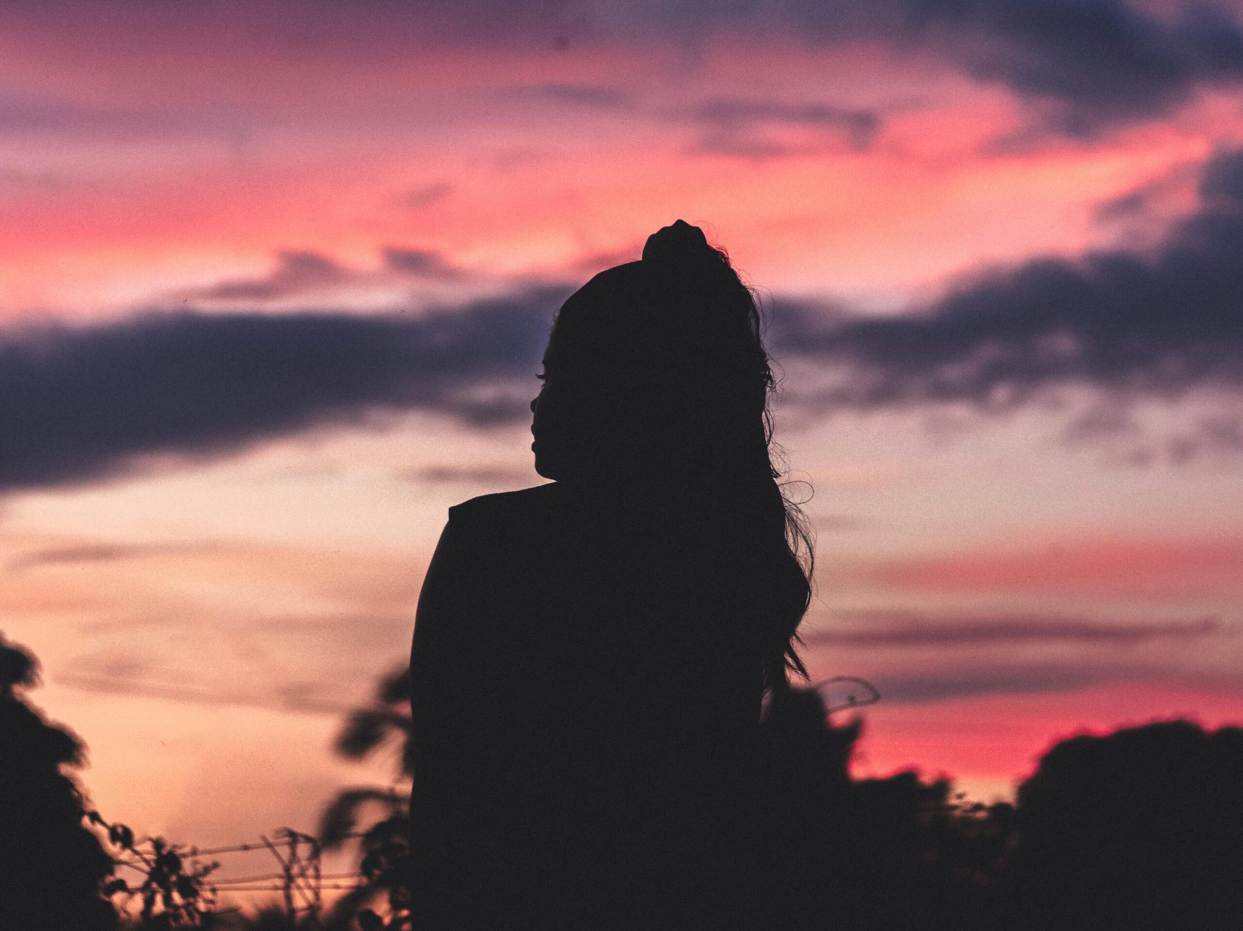 Woman sitting and watching the sunset.